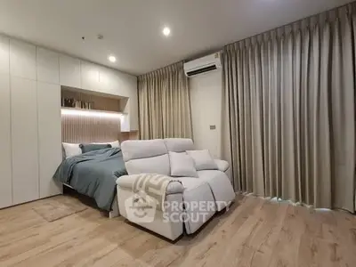 Modern bedroom with cozy seating and elegant curtains