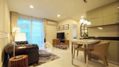 Stylish modern living room with elegant decor and open kitchen layout.