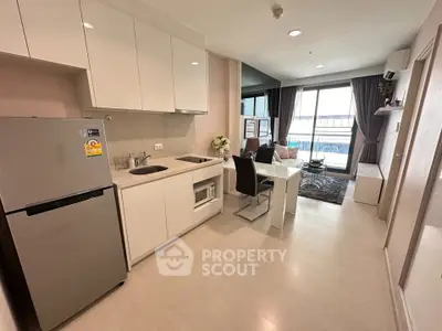 Modern open-layout kitchen and living room with sleek design and natural light