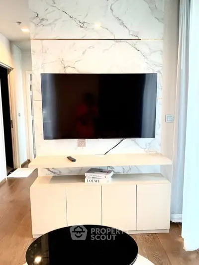Modern living room with marble accent wall and sleek TV setup