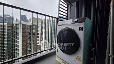 Modern balcony with city view and washing machine in high-rise apartment.