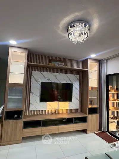 Modern living room with elegant TV unit and chandelier lighting