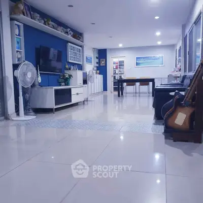 Spacious modern living room with sleek decor and ample natural light, perfect for family gatherings.