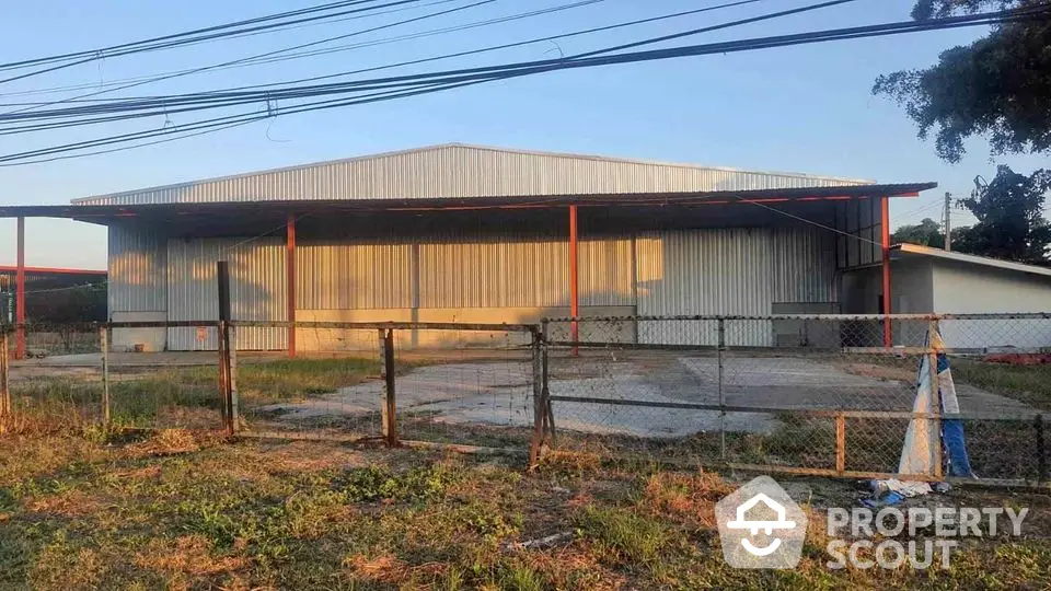 Spacious industrial warehouse with ample outdoor space and secure fencing.