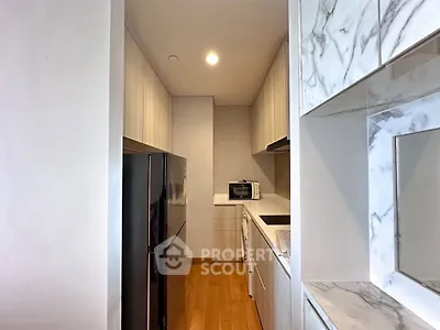 Modern kitchen with sleek appliances and marble accents