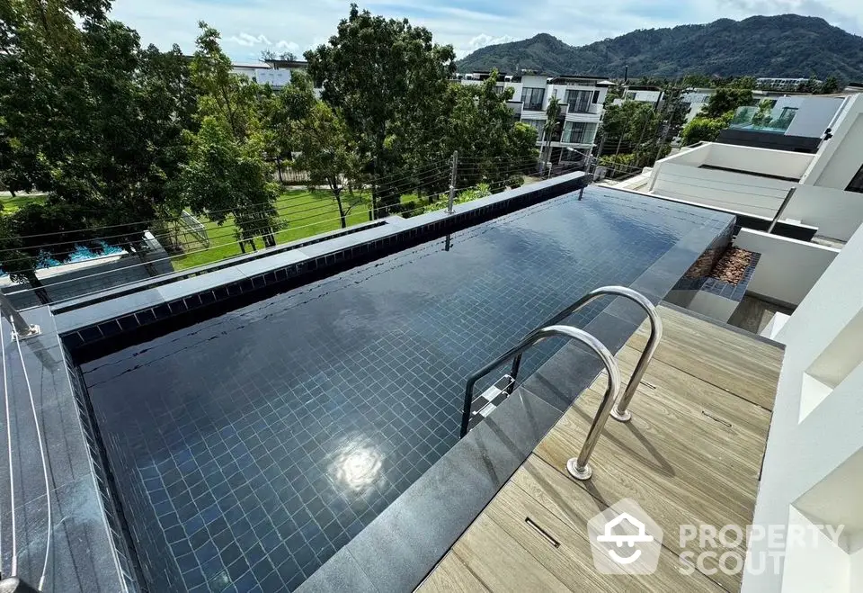 Stunning rooftop infinity pool with panoramic mountain views in luxury residential complex.