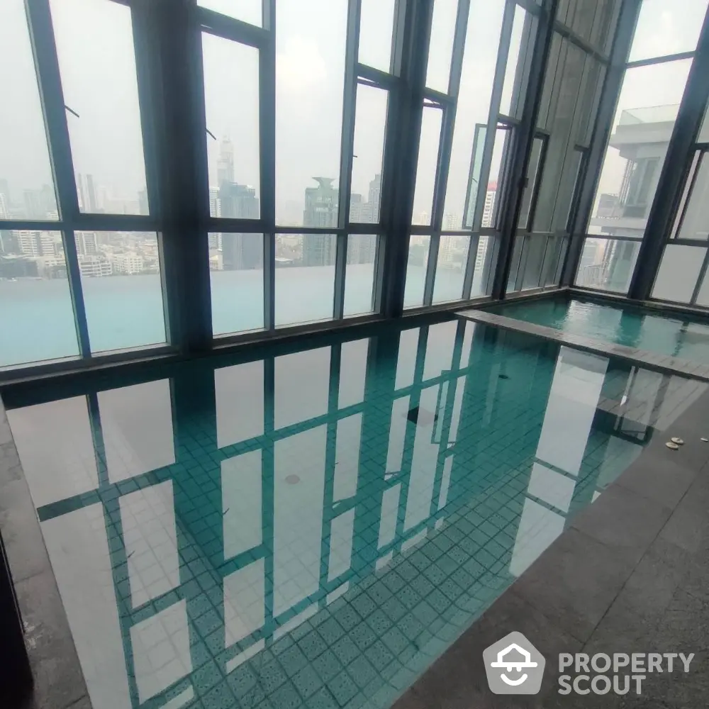 Luxurious indoor pool with stunning city view in high-rise building