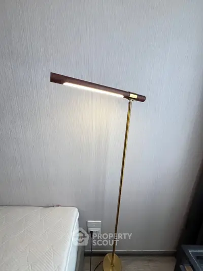 Modern bedroom with stylish floor lamp and minimalist decor