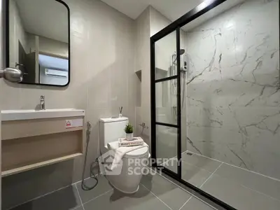 Modern bathroom with glass shower and sleek fixtures