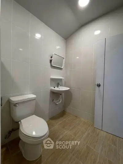 Modern bathroom with sleek tiles and compact fixtures