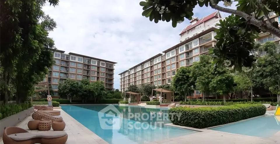 Luxurious residential complex with serene pool and lush greenery