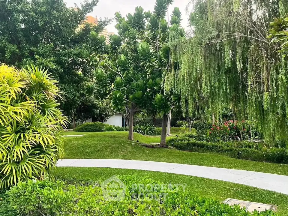 Lush green garden with winding pathways and vibrant foliage