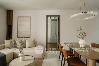 Elegant living and dining area with modern decor and neutral tones