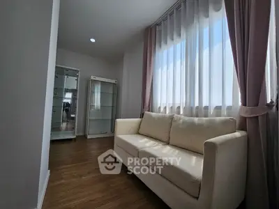 Bright and cozy living room with elegant sofa and large window curtains