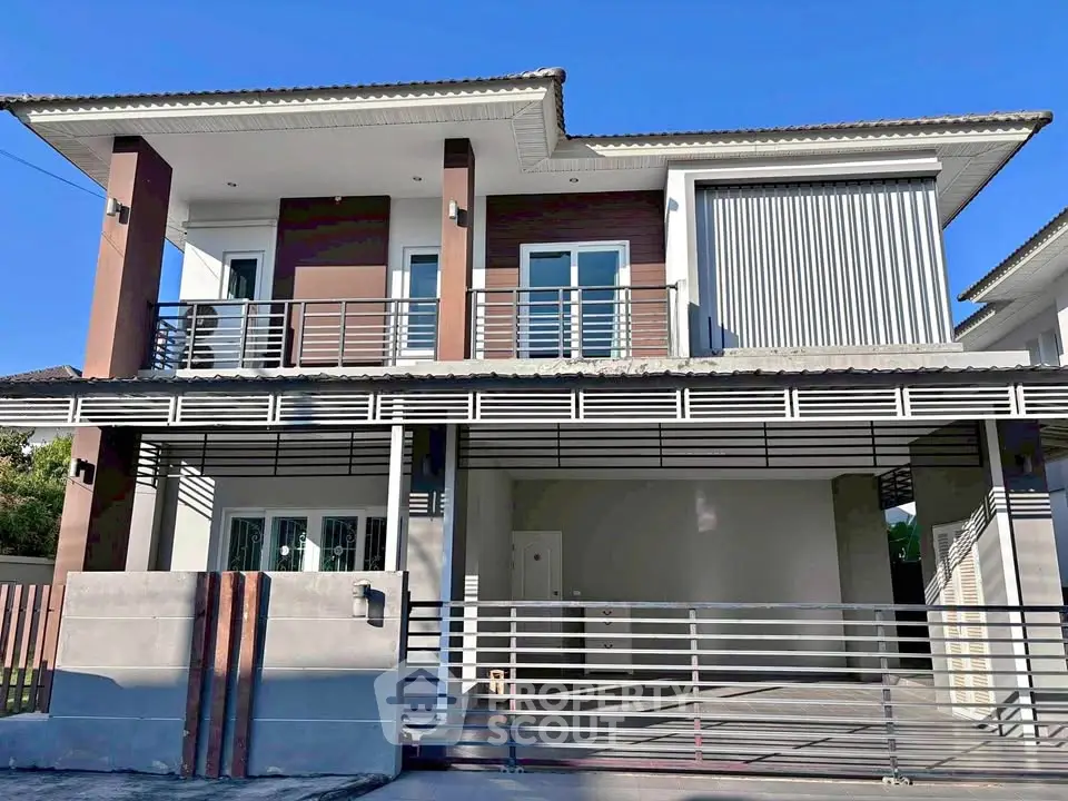 Modern two-story house with sleek design and spacious garage in a serene neighborhood.