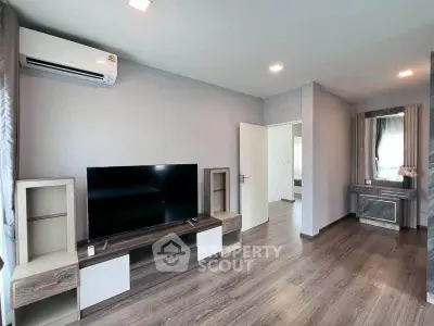 Modern living room with sleek furniture and wooden flooring