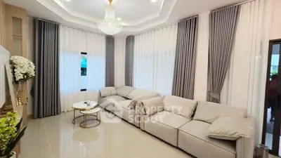 Luxurious living room with elegant chandelier and plush sofas