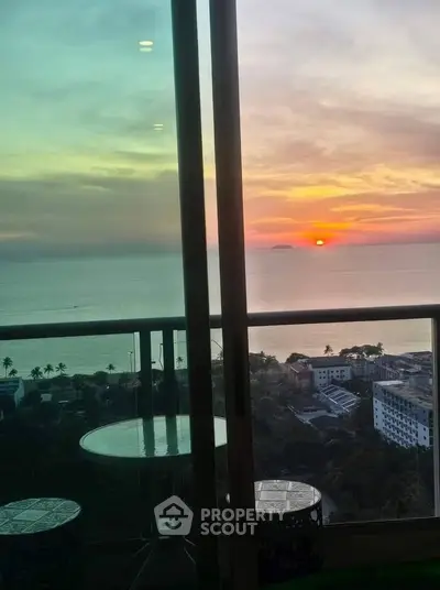 Stunning ocean view from high-rise balcony at sunset, perfect for serene living.