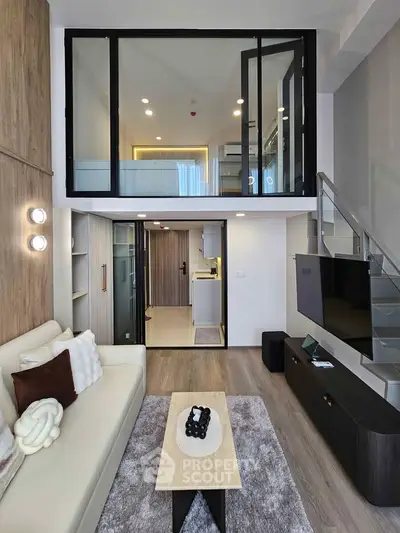 Modern duplex living room with stylish decor and open kitchen layout