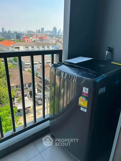Modern balcony with washing machine and city view, perfect for urban living convenience.