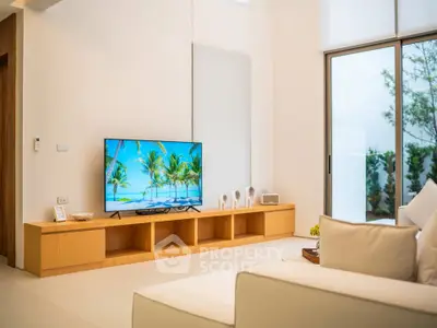 Spacious modern living room with sleek furniture and large TV, perfect for relaxation and entertainment.