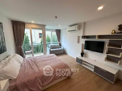 Modern bedroom with balcony access, featuring stylish decor and natural light.
