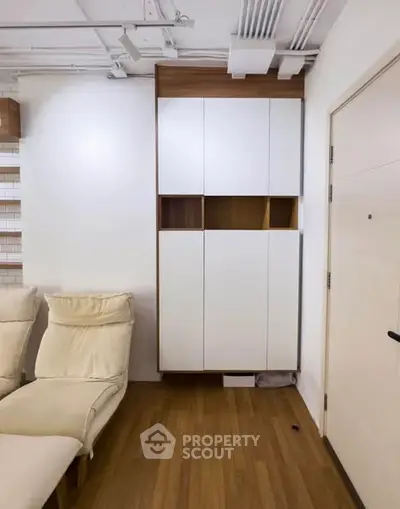 Modern living room with stylish white cabinets and cozy seating