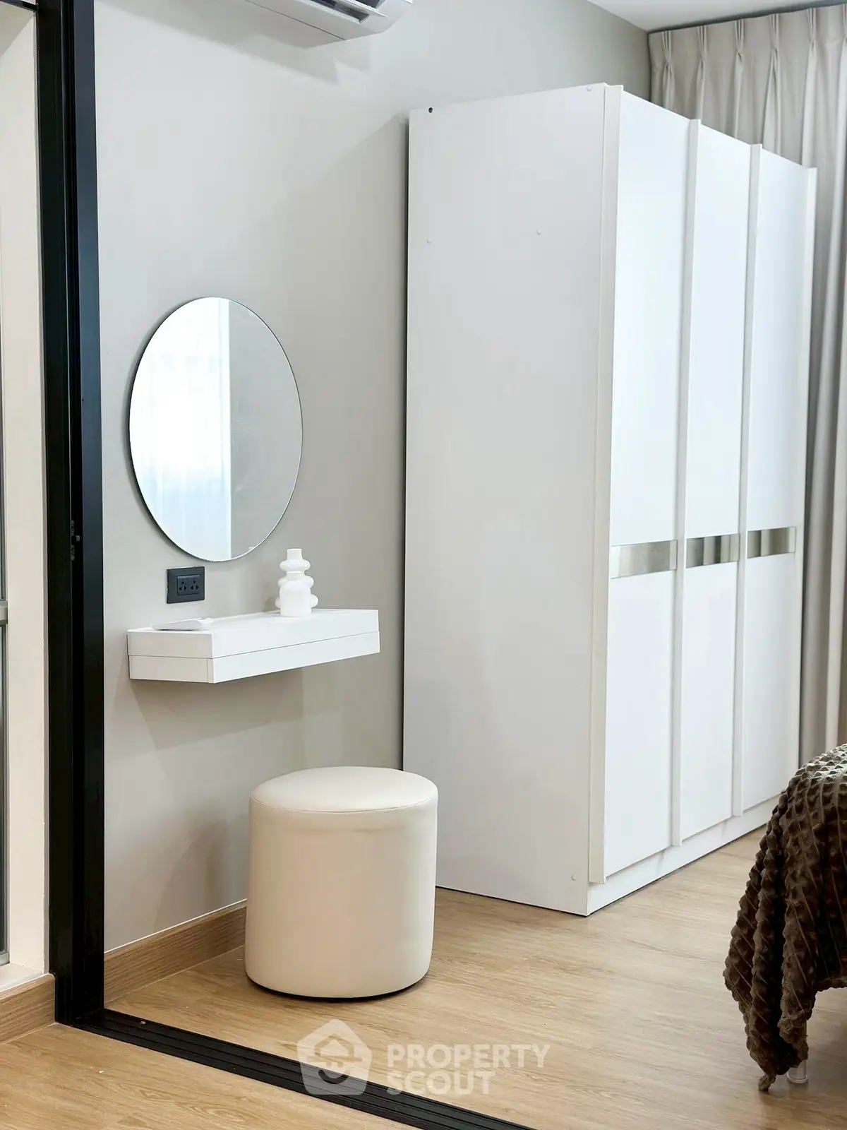 Modern bedroom with sleek white wardrobe and minimalist decor