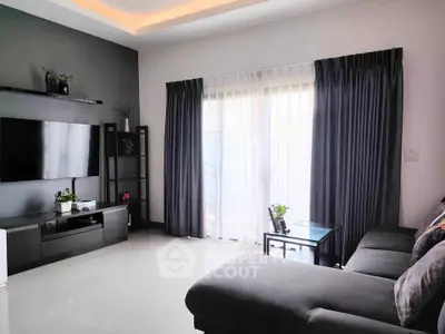 Modern living room with sleek furniture and large window for natural light.