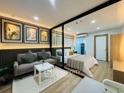 Modern studio apartment with stylish decor and cozy ambiance, featuring a comfortable living area and elegant bedroom.
