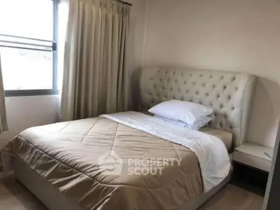 Cozy bedroom with elegant tufted headboard and soft lighting