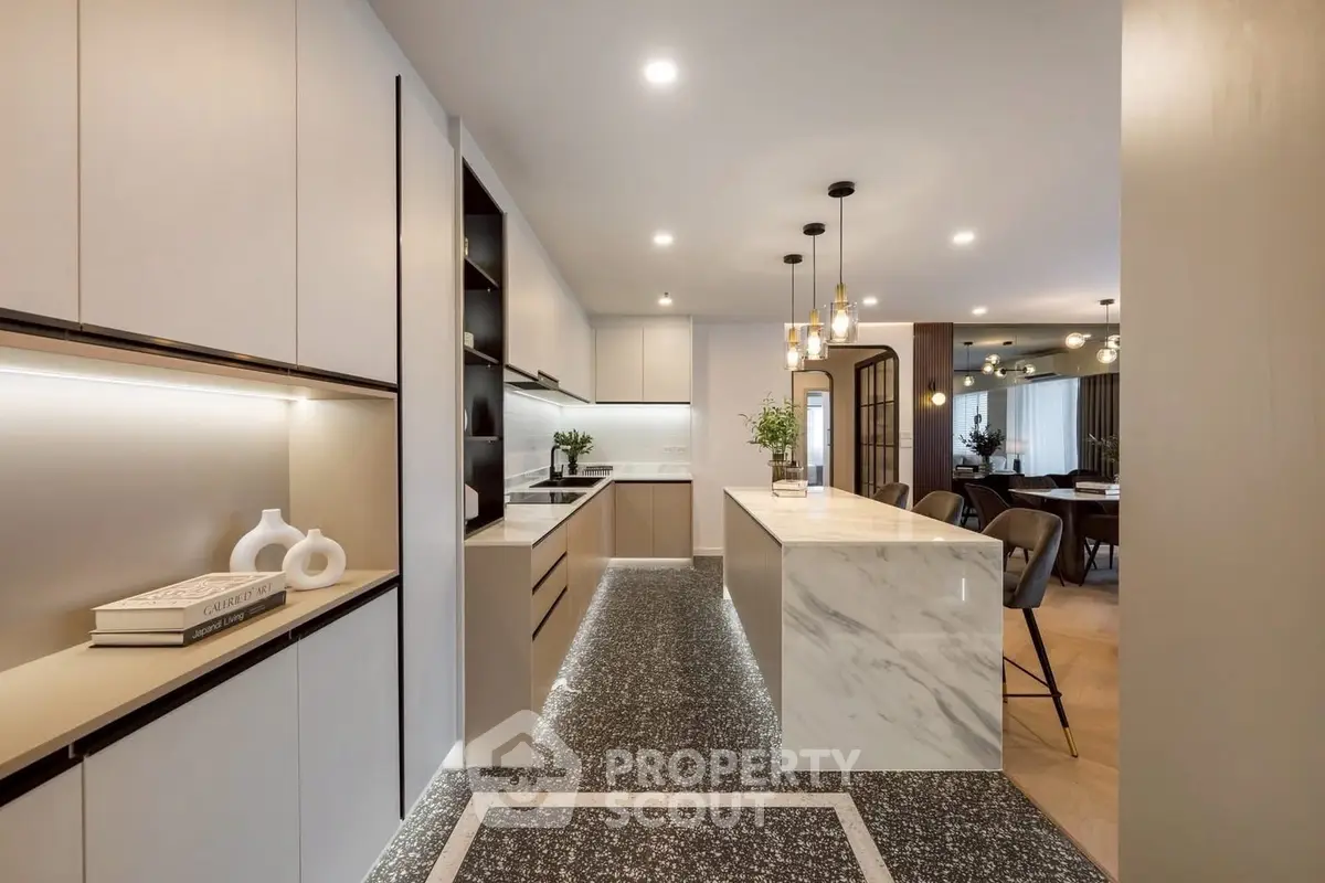Luxurious modern kitchen with marble island and elegant lighting