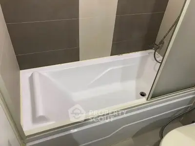 Modern bathroom with sleek bathtub and stylish tile design