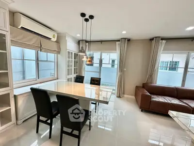 Modern living room with sleek furniture and large windows offering ample natural light.