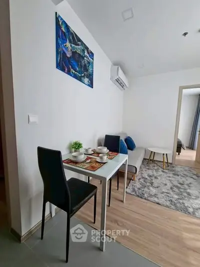 Modern living room with dining area and stylish decor in a cozy apartment.