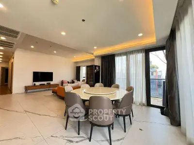 Spacious modern living room with elegant dining area and large windows for natural light.