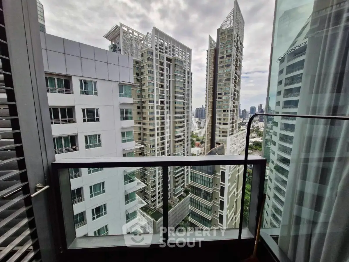 Stunning urban view from a modern apartment balcony with high-rise buildings.