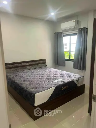 Cozy bedroom with modern bed and air conditioning, perfect for restful nights.