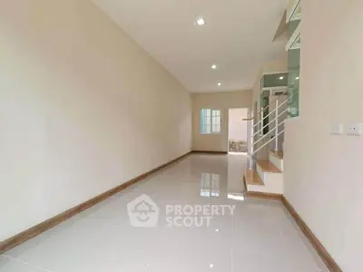 Spacious and bright interior with modern staircase and glossy tiled flooring