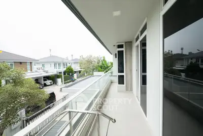 Spacious balcony with modern railing and neighborhood view
