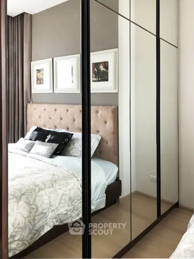 Elegant bedroom with mirrored wardrobe and stylish decor