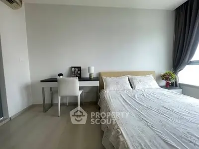 Modern bedroom with elegant decor and natural light, featuring a cozy bed and stylish desk.