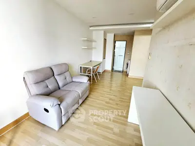 Modern living room with sleek design and comfortable seating in a stylish apartment.
