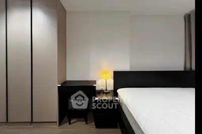 Modern bedroom with sleek furniture and ambient lighting, featuring a cozy bed and stylish wardrobe.