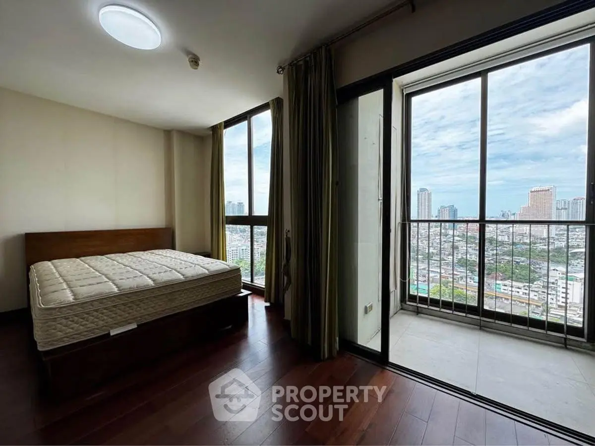 Spacious bedroom with stunning city view and large balcony access