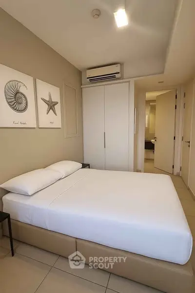 Modern bedroom with minimalist decor and air conditioning in a stylish apartment.