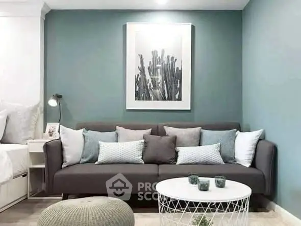 Stylish living room with modern gray sofa, decorative pillows, and chic wall art.