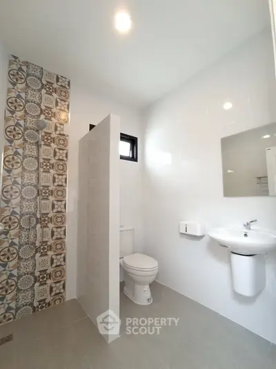 Modern bathroom with stylish tile shower and sleek fixtures