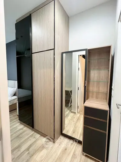 Modern bedroom with sleek wooden wardrobe and mirror