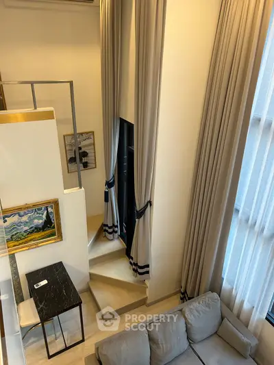 Luxurious modern loft with high ceilings and elegant drapery, featuring a cozy living area and stylish decor.